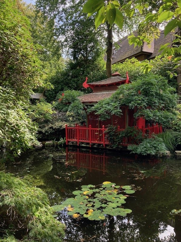 Traditional house, pond and garden in a Japanese themed setting at Compton Acres in Poole